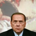 Italy's Prime Minister Berlusconi looks on during a news conference at Chigi Palace in Rome