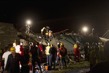 Emergency workers search for survivors after a building collapsed in Tongaat