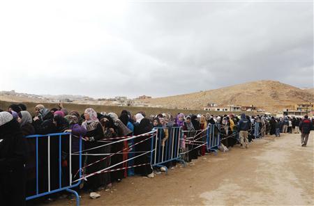 Syrians, fleeing the violence from the Syrian town of Qara, queue to register to get help from relief agencies at the Lebanese border town of Arsal, in the eastern Bekaa Valley