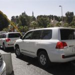 U.N. vehicles transporting a team of OPCW experts, leave their hotel in Damascus