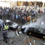 Soldiers, policemen and medical personnel gather at the site of explosions near the Iranian embassy in Beirut