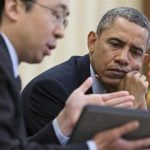 File handout photo of U.S. President Obama watches as CTO Park shows information on a tablet during a meeting in the Oval Office in Washington