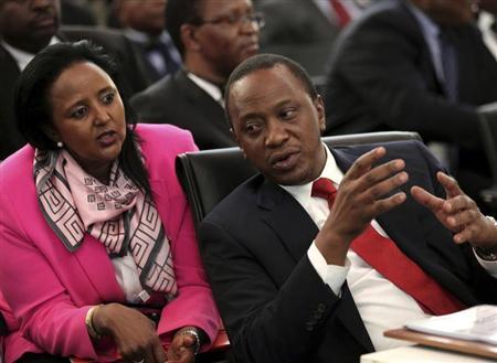 Kenyan President Uhuru Kenyatta chats with his Foreign Minister Amina Mohamed during the two-day meeting of SADC leaders in Pretoria