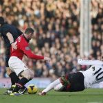 Manchester United's Rooney collides with referee Probert as he is challenged by Fulham's Ruiz during their English Premier League soccer match at Craven Cottage in London
