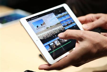 A member of the media holds the new iPad mini with Retnia display during an Apple event in San Francisco