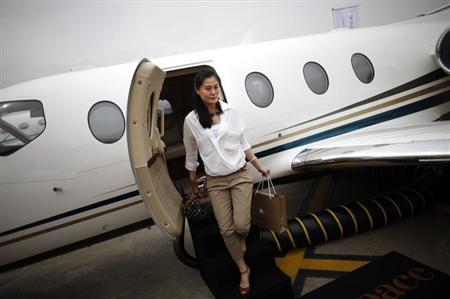 A guest descends from a Nextant Aerospace 400XT plane at the Shanghai International Business Aviation Show at the Hongqiao International Airport in Shanghai
