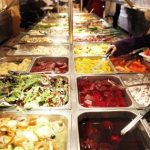 A girl helps herself to a buffet at a fast food restaurant in Harlem in New York