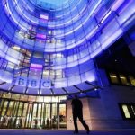 A man enters BBC New Broadcasting House in London