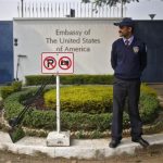 A private security guard stands outside the U.S. embassy in New Delhi
