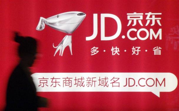 File photo of a woman walking past a advertisement board of Jingdong Mall in Nanjing