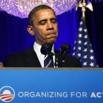 U.S. President Obama pauses while delivering remarks on Obamacare at an Organizing for Action grassroots supporter event in Washington