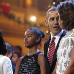The Obama family join performers onstage to sing Christmas carols during a taping of the Christmas in Washington television benefit program at the National Building Museum in Washington