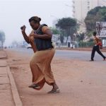 A woman runs from gunfire in Bangui