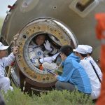 Chinese astronaut Nie waves before getting out of re-entry capsule of China's Shenzhou-10 spacecraft after it landed at its main landing site in Inner Mongolia Autonomous Region