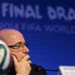 Blatter listens to a question during a news conference in Sao Joao da Mata