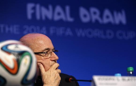 Blatter listens to a question during a news conference in Sao Joao da Mata