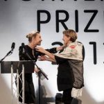 French-born film installation artist Laure Prouvost embraces Irish actress Saoirse Ronan after Ronan awarded Prouvost with this year's Turner Prize, in Londonderry, Northern Ireland