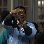 A polling agent calls for a break as they count votes at a polling centre in Antananarivo
