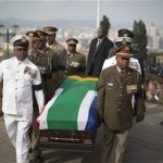 Military officers carry the coffin of former South African president Nelson Mandela to the Union Buildings