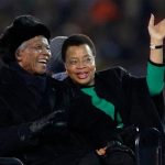 Nelson Mandela, left, sits next to his wife Graca Machel