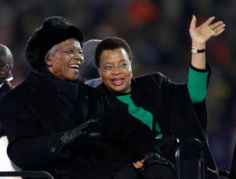 Nelson Mandela, left, sits next to his wife Graca Machel