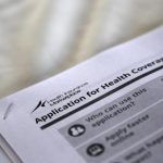Applications are seen at a rally held by supporters of the Affordable Care Act in Jackson, Mississippi