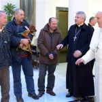 Pope Francis, right, prepares to meet homeless people