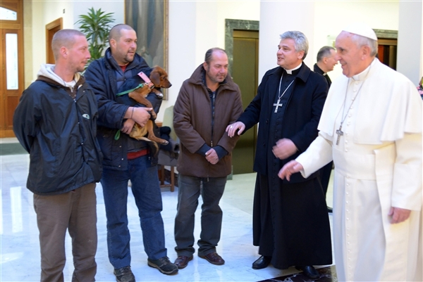 Pope Francis, right, prepares to meet homeless people