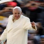 Pope Francis waves as he arrives to conduct his weekly general audience at St. Peter's Square at the Vatican
