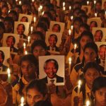 Schoolchildren hold candles and portraits of former South African President Mandela during prayer ceremony at school in Chennai