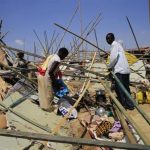 A displaced family from South Sudan's Nuer tribe erects a makeshift shelter inside the UNAMIS facility in Jabel