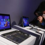 Members of the media take pictures of Surface 2 tablets during the launch of the Microsoft Surface 2 tablets in New York