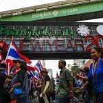 Anti-government protesters march during a rally at a major business district in Bangkok