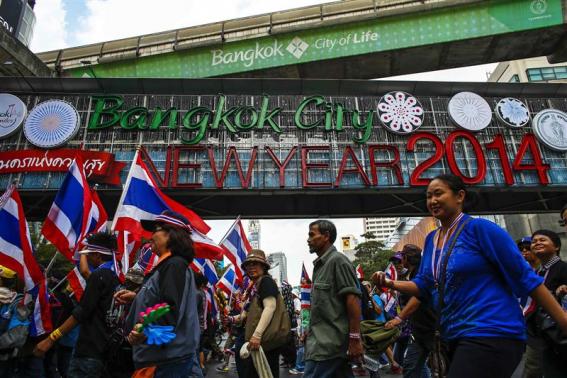 Anti-government protesters march during a rally at a major business district in Bangkok