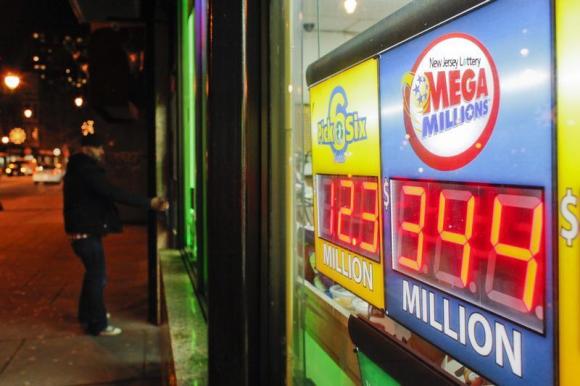 A customer arrives at a store where a Mega Millions sign is seen after the lottery grand prize rose to $344 million in New York