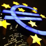 An illuminated euro sign is seen in front of the headquarters of the European Central Bank in Frankfurt