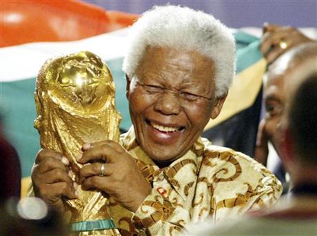 former South African President Nelson Mandela lifts the World Cup trophy in Zurich