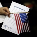 A woman holds the Oath of Allegiance at a naturalization ceremony for new U.S. citizens in Los Angeles