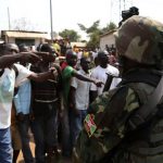 Angry men point at AU soldiers at Gobongo district in Bangui