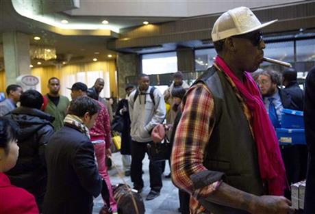 Former NBA basketball star Dennis Rodman, right, and fellow U.S. basketball players arrive at a hotel in Pyongyang, North Korea Monday, Jan. 6, 2014. Rodman arrived in the North Korean capital with a squad of former basketball stars in what he calls "basketball diplomacy," although U.S. officials have criticized his efforts. (AP Photo/David Guttenfelder)