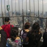 Visitors stand on the observation deck of the Empire State building in New York