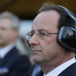 French President Hollande watches a Mirage 2000-5 who taxis out of his hangar during a visit to the Creil military airbase as he presents New Year wishes to the French Army in Creil