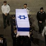 Members of the Knesset guard carry the coffin of late Israeli Prime Minister Ariel Sharon