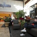 A man sleeps on a couch outside of a Neiman Marcus store at South Park mall in Charlotte