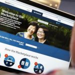 A man looks over the Affordable Care Act signup page on the HealthCare.gov website in New York in this photo illustration