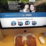 A man looks over the Affordable Care Act signup page on the HealthCare.gov website in New York in this photo illustration