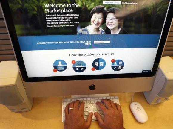 A man looks over the Affordable Care Act signup page on the HealthCare.gov website in New York in this photo illustration