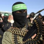 File photo of Palestinian members of the al-Qassam brigades standing guard as they wait for the arrival of Hamas chief Meshaal in the southern Gaza Strip