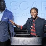Rapper Williams accepts the Golden Note Award as Platt, president of EMI Music Publishing, looks on at the 25th Annual ASCAP Awards in Beverly Hills