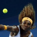 Serena Williams of the U.S. serves to Victoria Azarenka of Belarus during their women's final match at Brisbane International tennis tournament